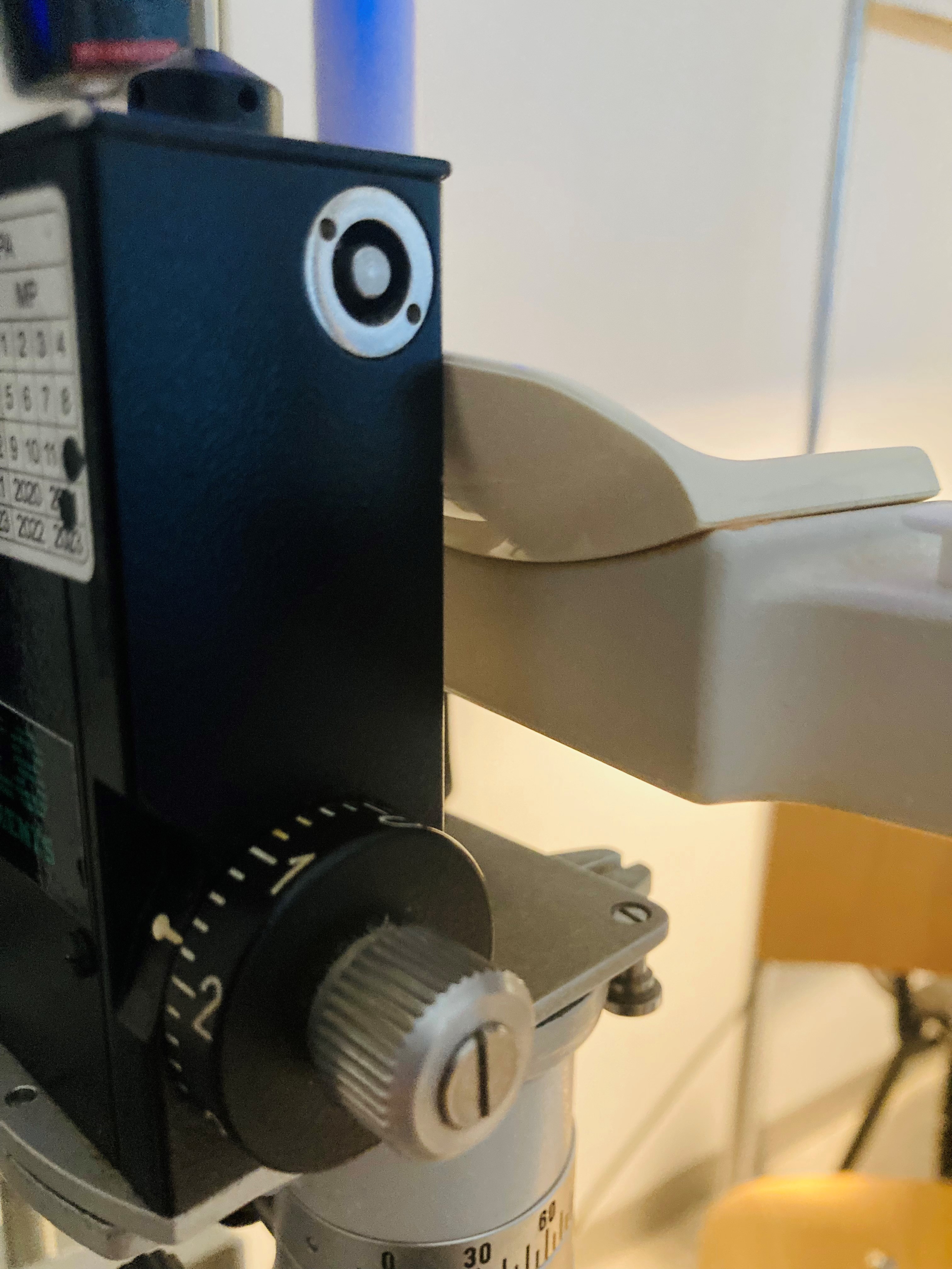 The Goldmann Applanation Tonometer (GAT) is equipped with a dial to measure intraocular pressure (IOP) in millimeters of mercury (mmHg)