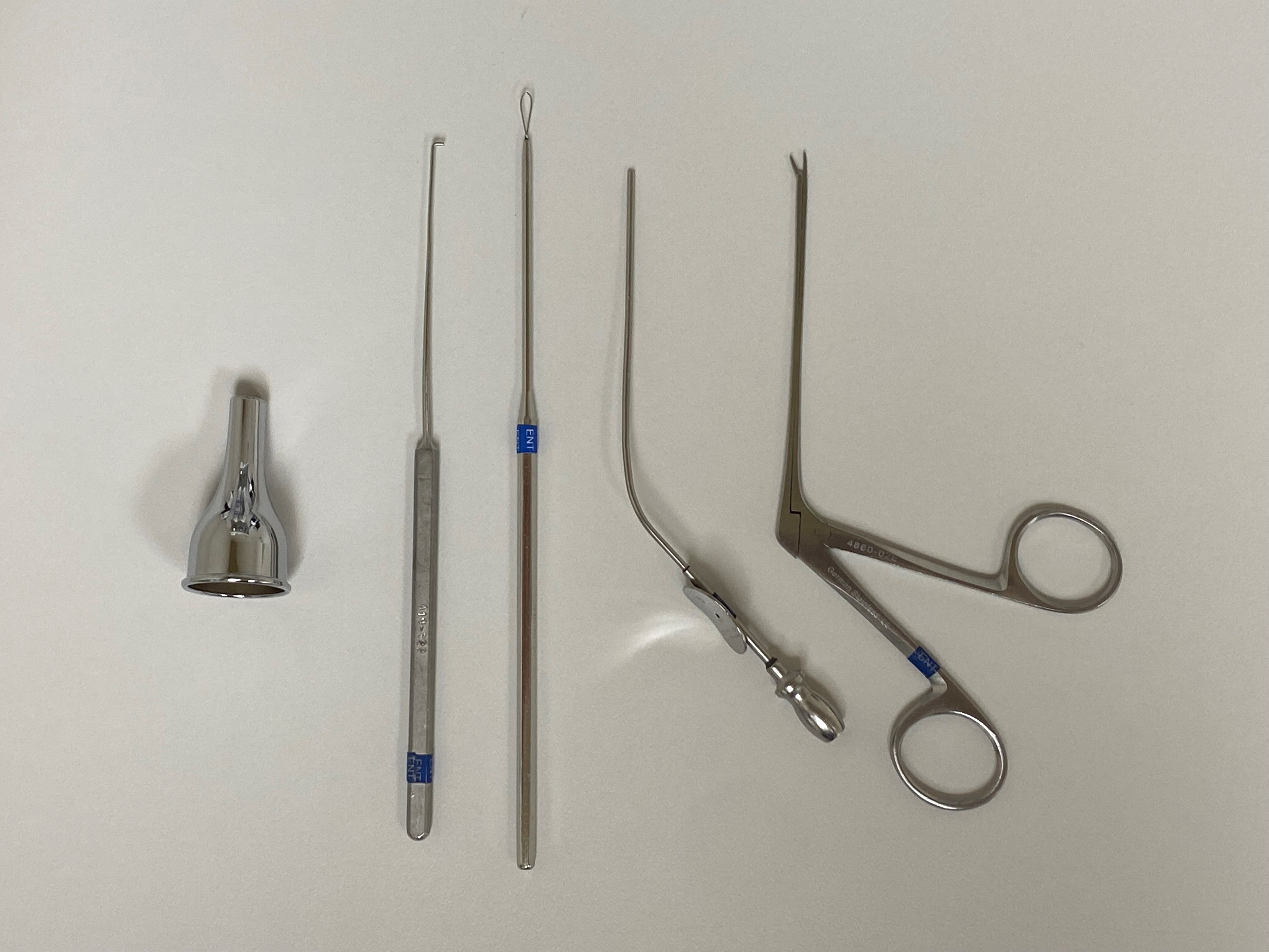 Instruments that may be used for cerumen removal, from left to right: otologic speculum, right angle hook, cerumen loop, 5 French suction tip, alligator forceps