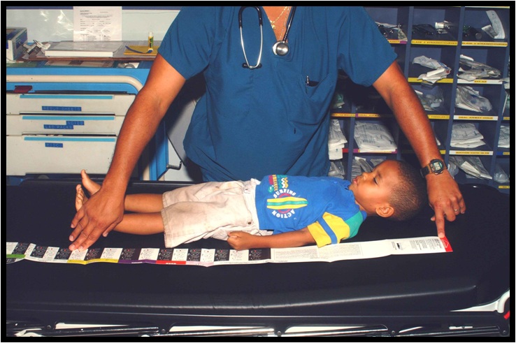 <p>Broselow Tape Measurement. This image shows a clinician measuring a child's height using the Broselow Tape.</p>